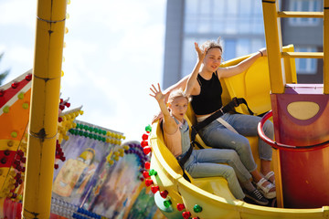 Yellow carousel in a summer city park.