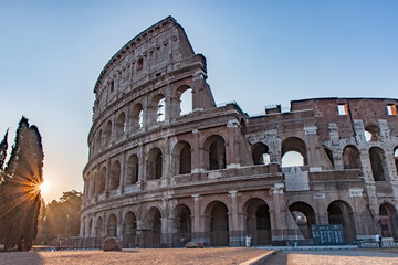 Fototapeta na wymiar Sunrise Rays by the Colosseum in Rome Italy
