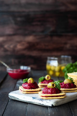 Beetroot relish on crackers. An original party snack.