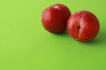 Delicious plums in colorful background