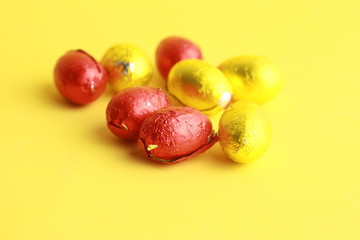 chocolate easter eggs, wrapped in yellow and red paper