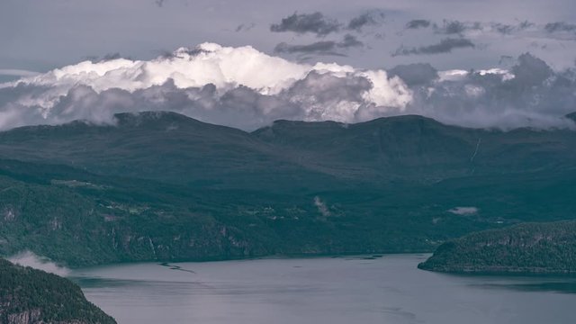 Aerial view of the clouds passing and swirling over the waters of the Innvikfjorden. A timelapse video.