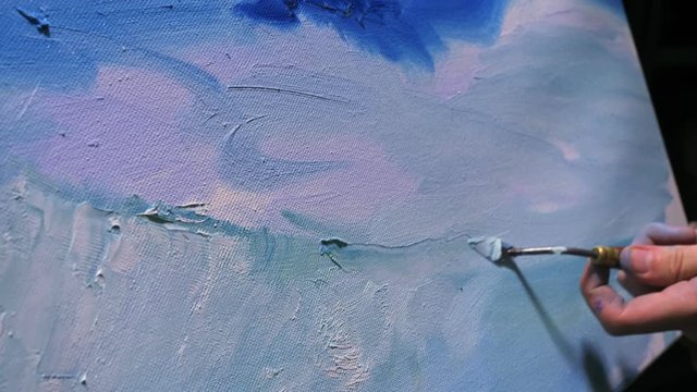 Artist copyist paint seascape with ship in ocean. Craftsman decorator draw as boat sail on blue sea with acrylic oil color. Draw finger, brush, knife palette. Indoor. Close up cinematic look.