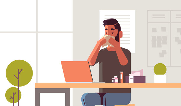 sick businessman blowing nose with handkerchief unhealthy guy sitting at workplace using laptop man having flu sneeze illness concept modern office interior flat portrait horizontal vector