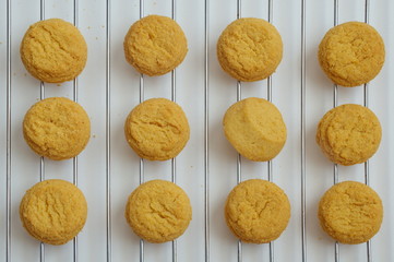 Directly above shot of the cookies on a gridiron against the white background