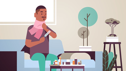 sick man measuring temperature with thermometer unhealthy african american guy in scarf suffering from cold flu virus illness concept modern living room interior flat portrait horizontal vector
