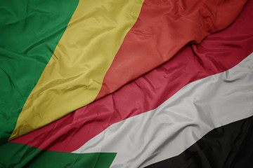 waving colorful flag of sudan and national flag of republic of the congo.