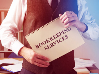 Bookkeeping services sign and accountant in the office.