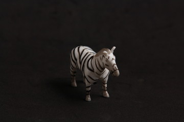 plastic toy with zebra shape in color background