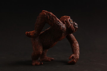 orangutan shaped plastic toy in color background