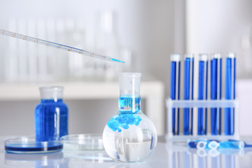 Dripping of color sample into flask in laboratory