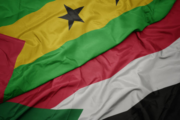 waving colorful flag of sudan and national flag of sao tome and principe .