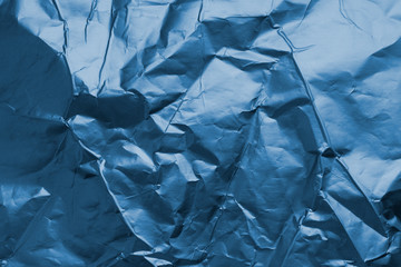 Crumpled paper, matt foil texture for background. Classic Blue color. Color of the year 2020. Trendy color.