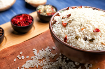 Bowl with raw rice on table, closeup