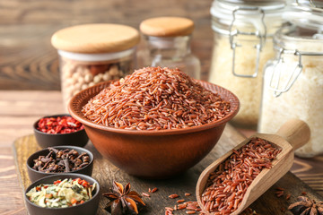 Raw rice and dry vegetables with spices on table