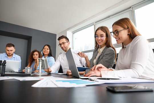 Colleagues discussing issue at business meeting in office