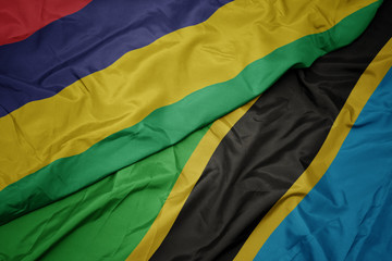 waving colorful flag of tanzania and national flag of mauritius.