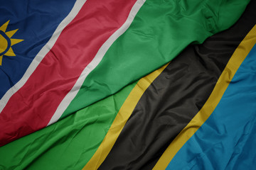 waving colorful flag of tanzania and national flag of namibia.