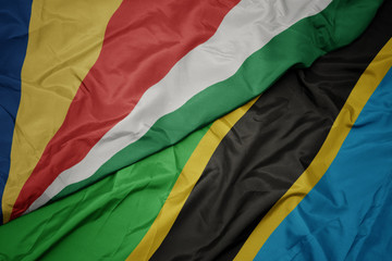 waving colorful flag of tanzania and national flag of seychelles.