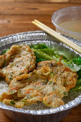 angle view fast food of fried fish cutlet and cabbage and rice with bowl of soup vertical composition