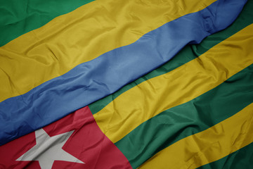 waving colorful flag of togo and national flag of gabon.