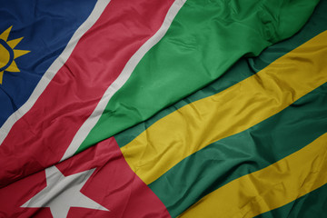 waving colorful flag of togo and national flag of namibia.