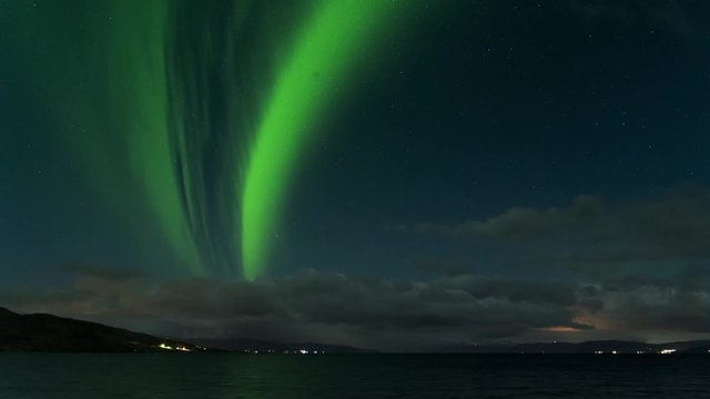 Northern lights, polar light or Aurora Borealis night sky over ocean rainbow in Narvik City in Northern Norway Lofoten