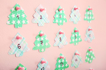 Creative Christmas calendar on color wall