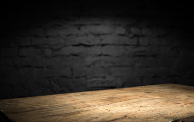 Wood table in front of rustic brick wall blur background with empty copy space on the table for...