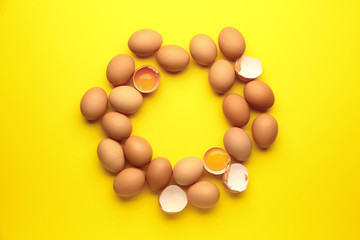 Frame made of fresh eggs on color background