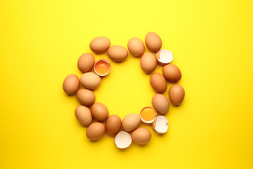 Frame made of fresh eggs on color background