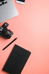 Flatley with camera, laptop and phone. Minimalist layout of the photographer on a bright background.