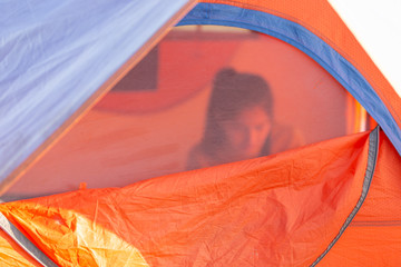 Fototapeta na wymiar young couple camping front of tent in the morning