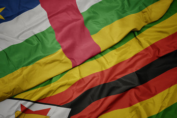 waving colorful flag of zimbabwe and national flag of central african republic.