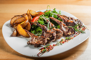 Grilled ribs cooked with vegetables and rosemary.