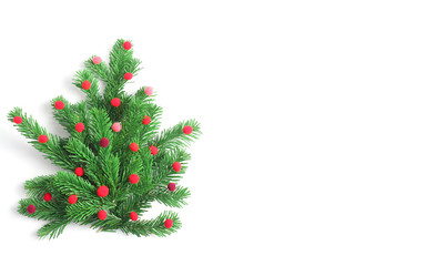 Christmas tree made of fir branches, decorated with red balls. Simple flat lay composition. Horizontal banner, copy space