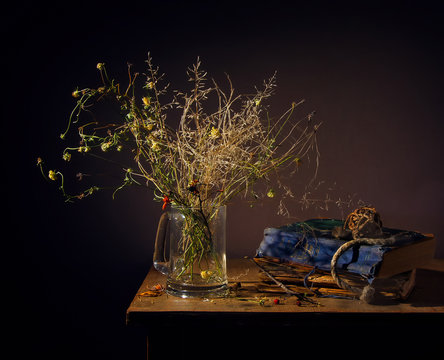 Still life with a bouquet of dried wildflowers and old books. Vintage. Retro.