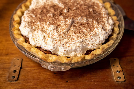 Cream pie dessert on wood table with hinges