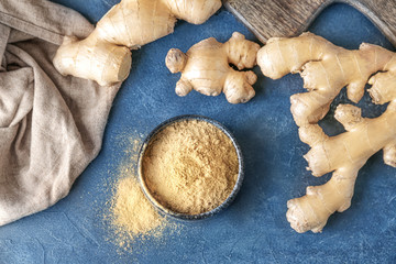 Fresh and ground ginger on dark background