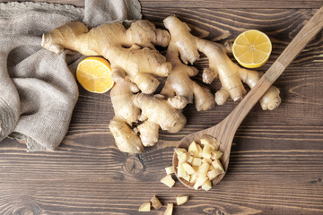 Fresh ginger with lemon on wooden table