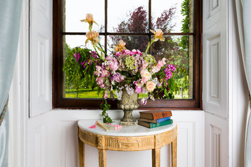 Fototapeta na wymiar Spectacular flower arrangement in the window of a stately home.