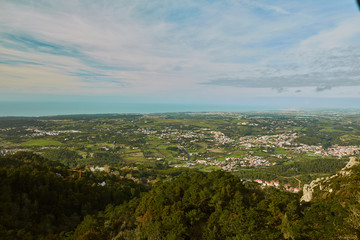 panorama of mountains with trees and clouds