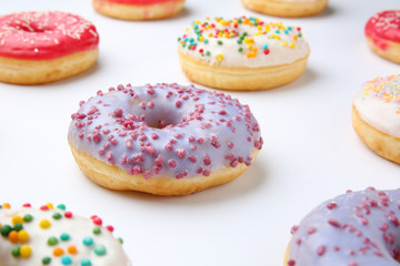 Sweet tasty donuts on white background