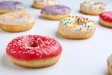 Sweet tasty donuts on white background