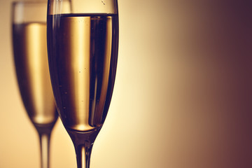 Two glasses of champagne on a blurred background. Celebration concept. Selective focus. Background with copy space.