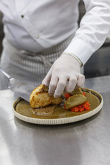 chef cooks a culinary dish in the restaurant kitchen.