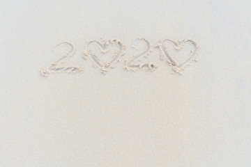 Concept Happy New Year 2020 on the beach Tropical design made in Phuket, Thailand Write the alphabet on the sand background Taken from real locations.