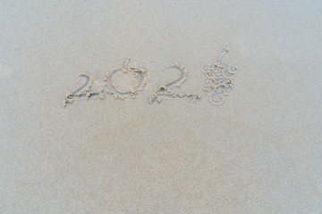Concept Happy New Year 2020 on the beach Tropical design made in Phuket, Thailand Write the alphabet on the sand background Taken from real locations.