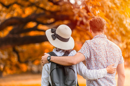 couple lover people have a good memory for walking relax in the park in autume season back view.