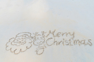 Concept Christmas on the beach Tropical design made in Phuket, Thailand Write the alphabet on the sand background Taken from real locations.